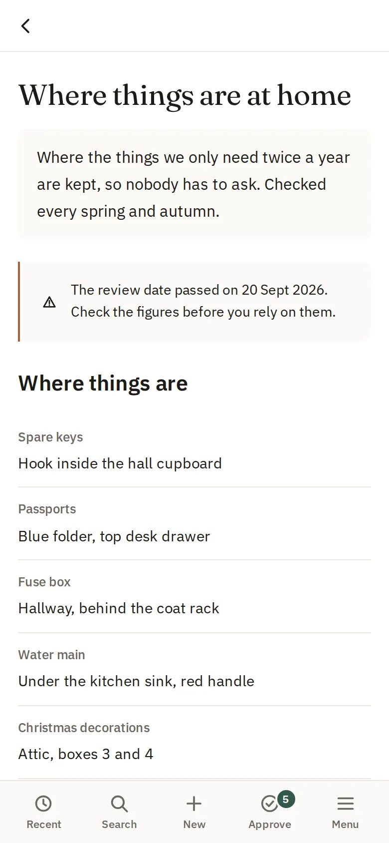 A note on a phone listing where things are kept at home, with a reminder that its review date has passed